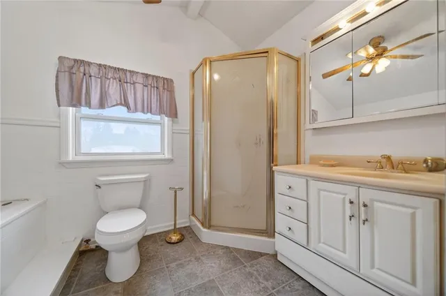 a bedroom with a bed and a dresser with mirror