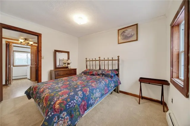 an empty room with chandelier fan and windows