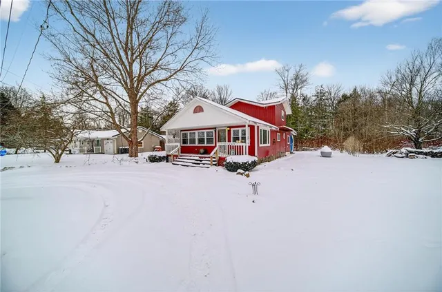 a view of house with outdoor space and sitting area
