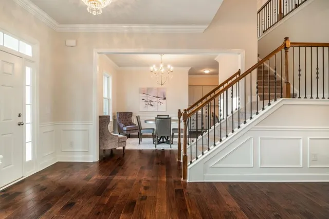 a living room with furniture a flat screen tv and a large window