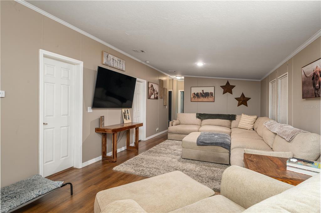 15079 Brahma Road Polk City, FL 33868 - Photo 17 of 40 a living room with furniture and a flat screen tv