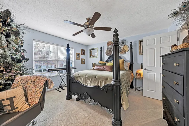 a bathroom with a granite countertop sink a toilet and a mirror
