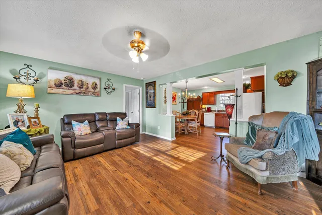 a living room with furniture and wooden floor