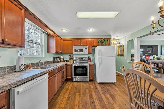 a view of a dining room with furniture wooden floor and window