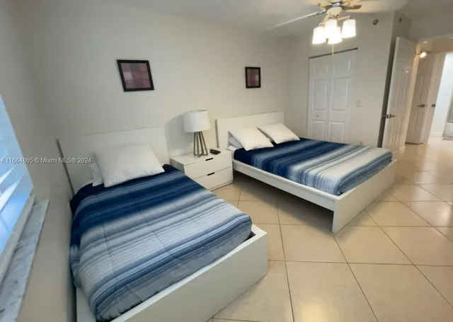 a spacious bedroom with a bed and a mirror