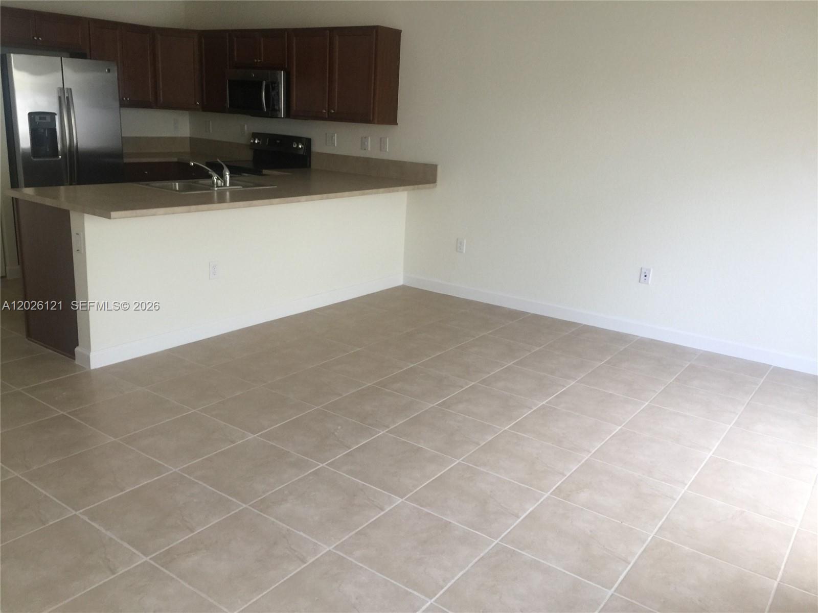 9307 West 33rd Way Hialeah, FL 33018 - Photo 6 of 23 a kitchen with a sink and cabinets