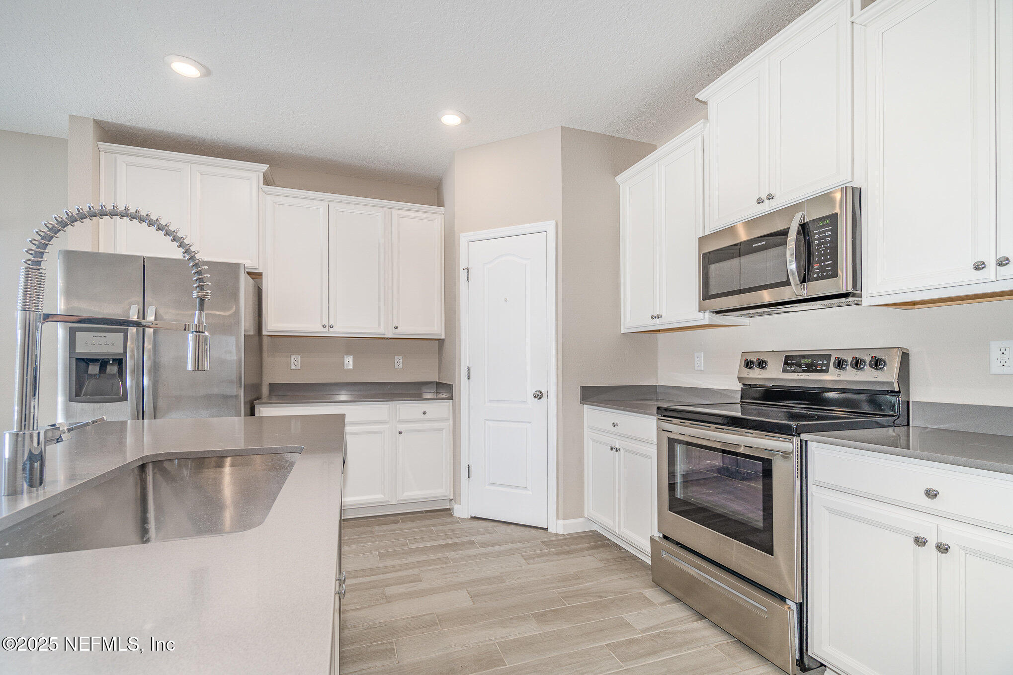 4220 Arbor Mill Circle Orange Park, FL 32065 - Photo 11 of 23 a kitchen with stainless steel appliances granite countertop a stove and a sink