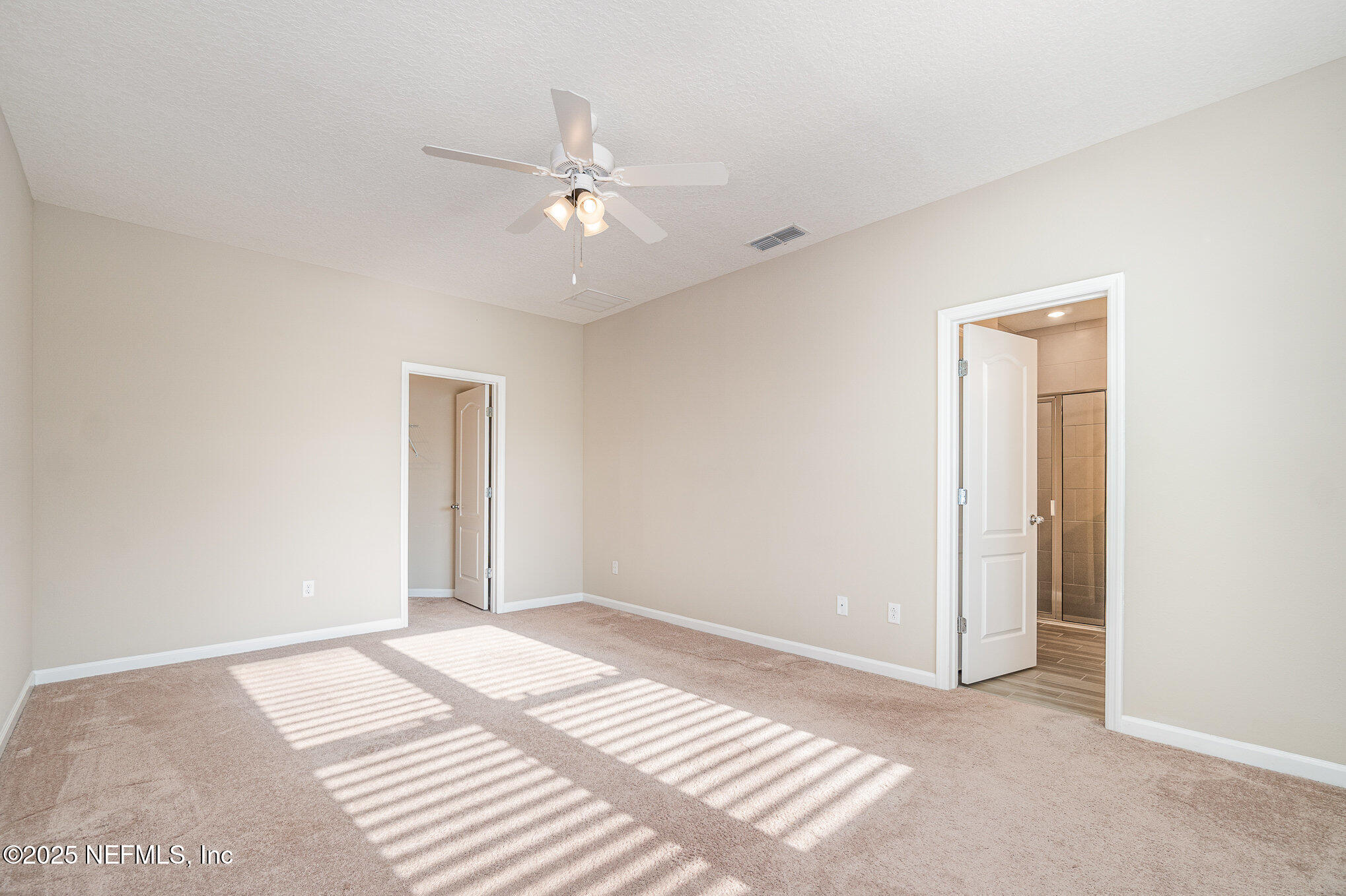 4220 Arbor Mill Circle Orange Park, FL 32065 - Photo 13 of 23 a view of a room with a ceiling fan and a window