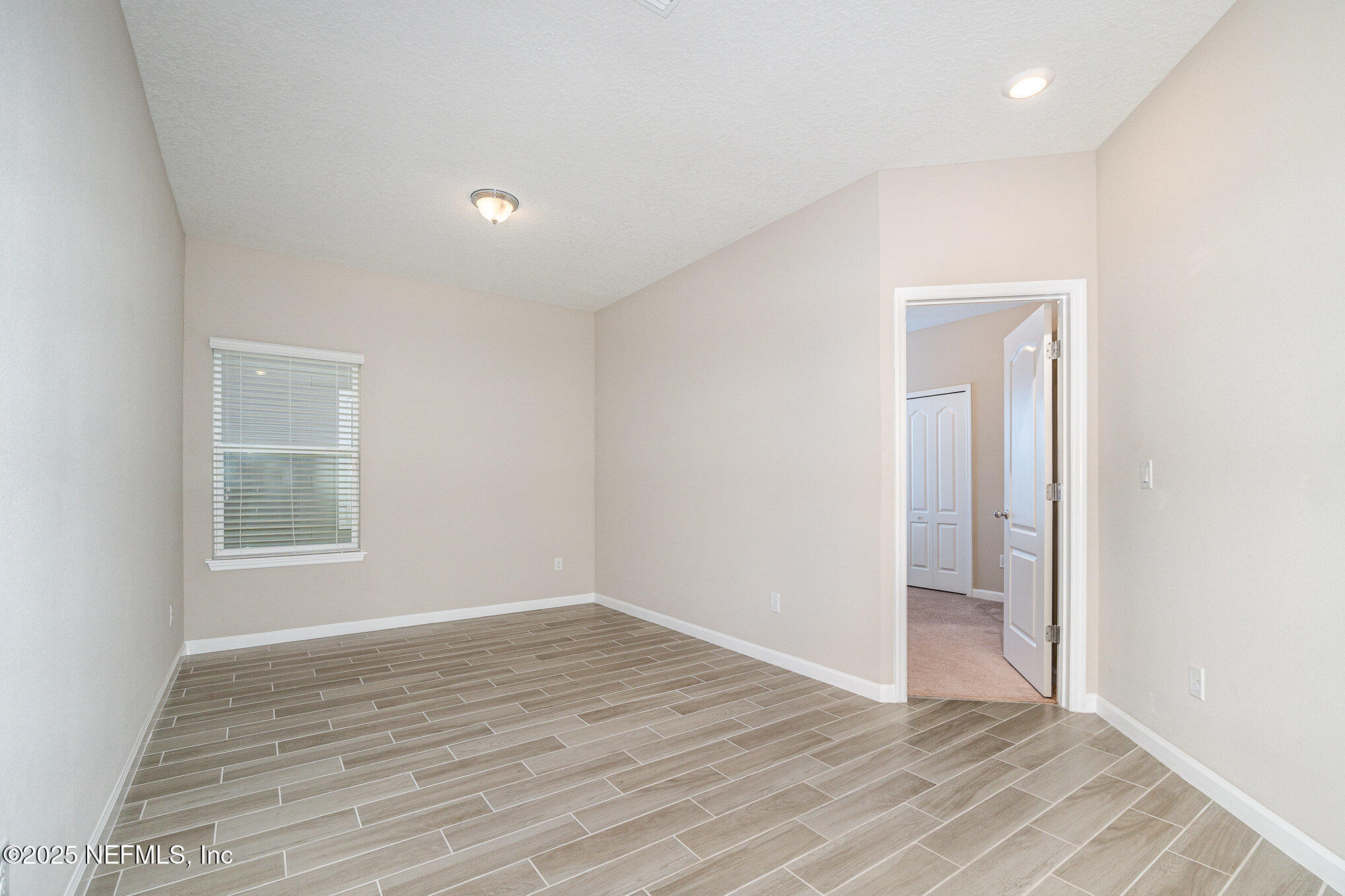 4220 Arbor Mill Circle Orange Park, FL 32065 - Photo 16 of 23 an empty room with wooden floor and windows