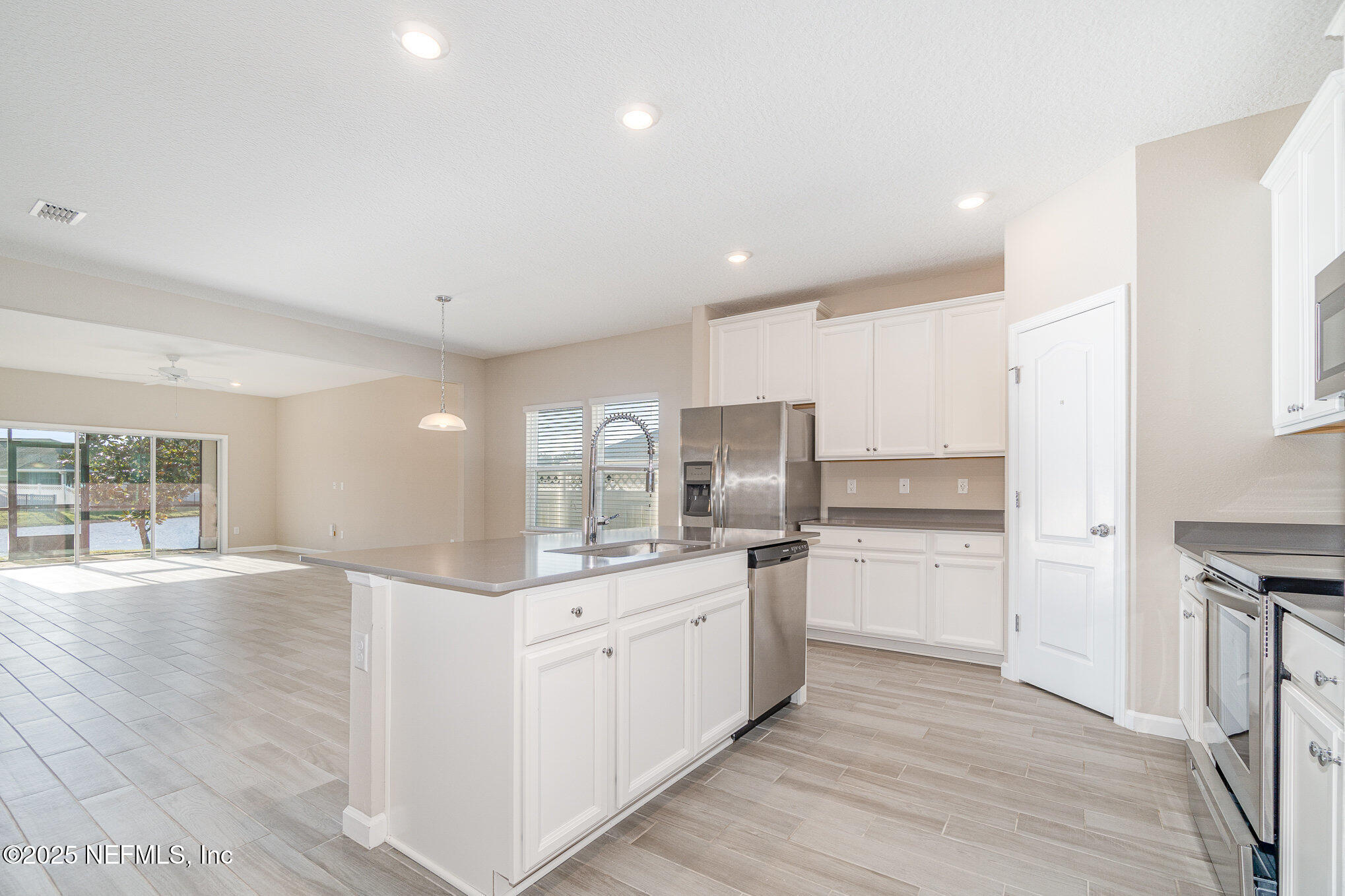 4220 Arbor Mill Circle Orange Park, FL 32065 - Photo 6 of 23 a kitchen with stainless steel appliances a refrigerator sink and cabinets