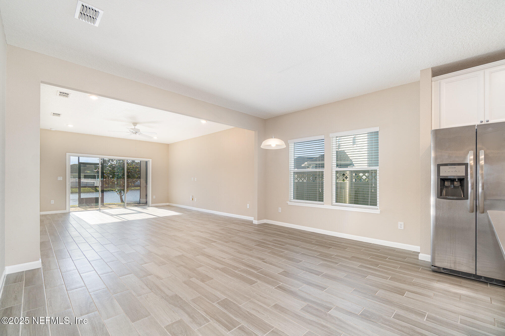 4220 Arbor Mill Circle Orange Park, FL 32065 - Photo 7 of 23 a view of an empty room with wooden floor and a window