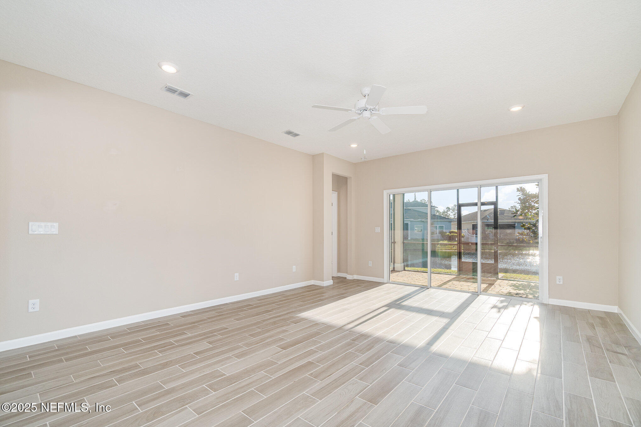 4220 Arbor Mill Circle Orange Park, FL 32065 - Photo 8 of 23 wooden floor in an empty room with a window