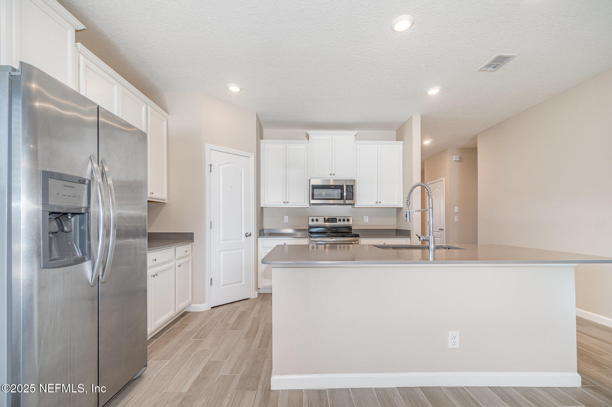 4220 Arbor Mill Circle Orange Park, FL 32065 - Photo 10 of 23 a kitchen with stainless steel appliances granite countertop a refrigerator a stove and a sink