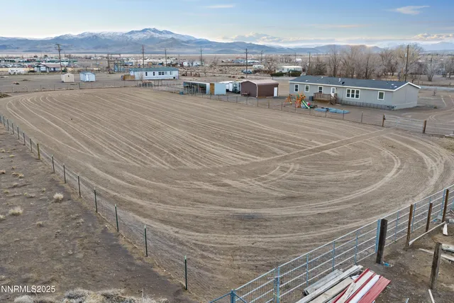 a front view of residential houses with cars parked
