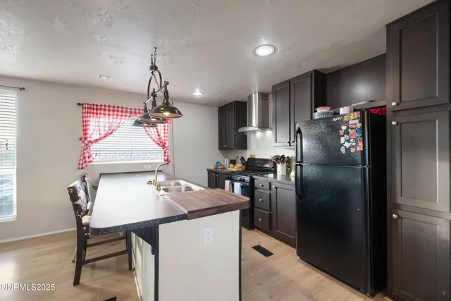 a living room with furniture dining table a flat screen tv and a large window