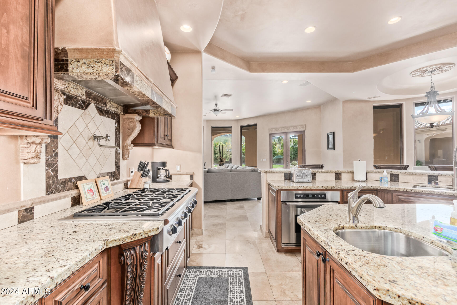 5339 East Royal Palm Road Paradise Valley, AZ 85253 - Photo 11 of 95 a kitchen with granite countertop a sink stove and cabinets