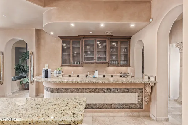 a bathroom with a sink mirror and a toilet