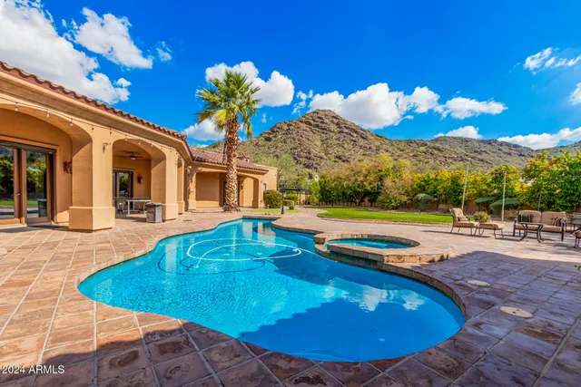 a view of a swimming pool with an outdoor seating space