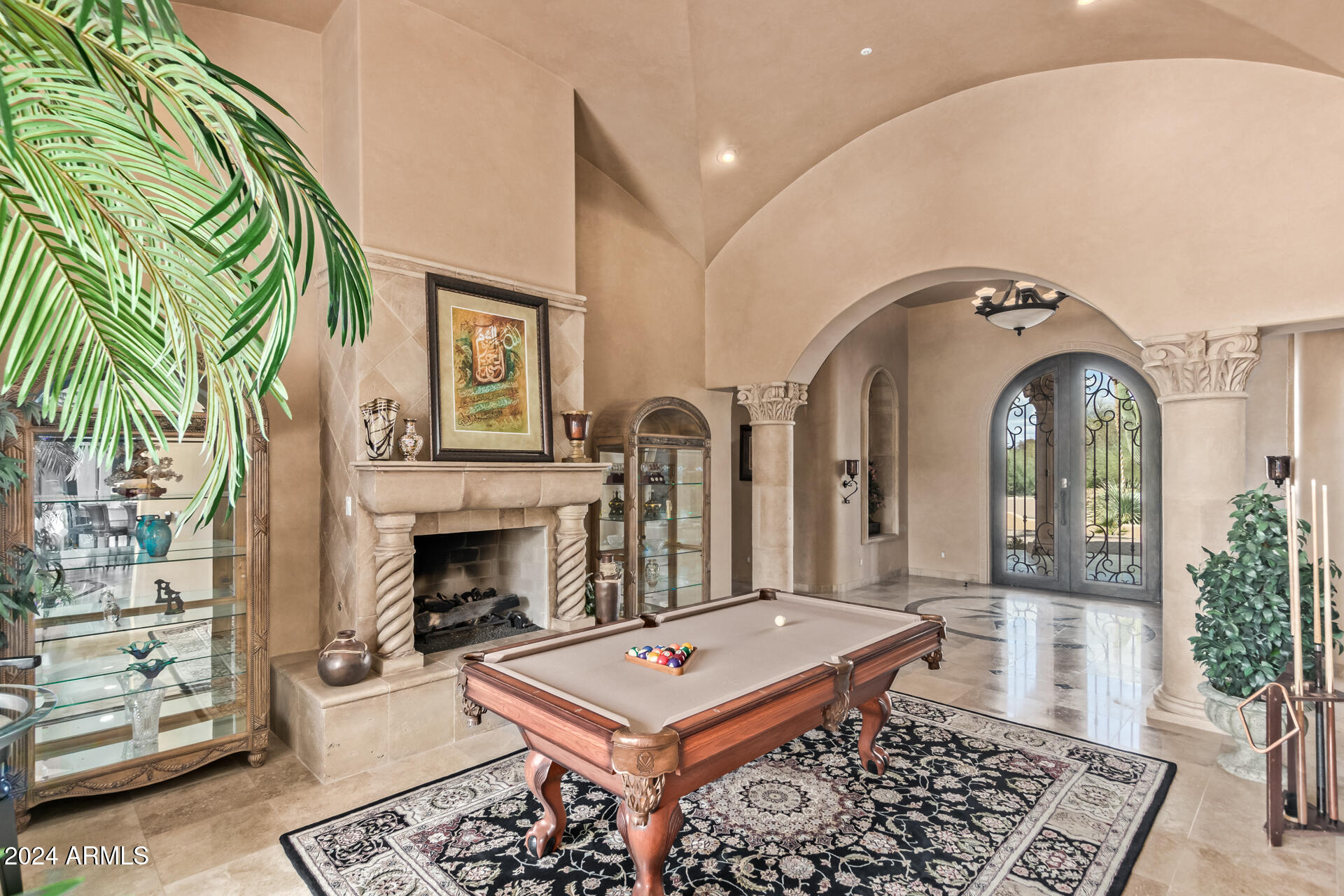 5339 East Royal Palm Road Paradise Valley, AZ 85253 - Photo 21 of 95 a living room with furniture a fireplace and a potted plant