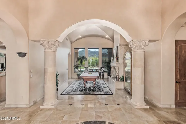 a living room with furniture and large windows