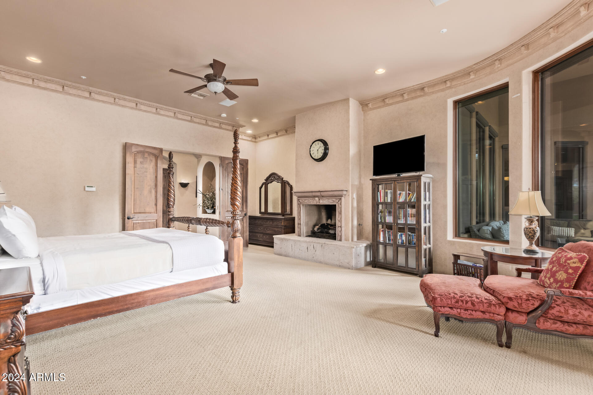 5339 East Royal Palm Road Paradise Valley, AZ 85253 - Photo 29 of 95 a spacious bedroom with a bed a chandelier and a couch