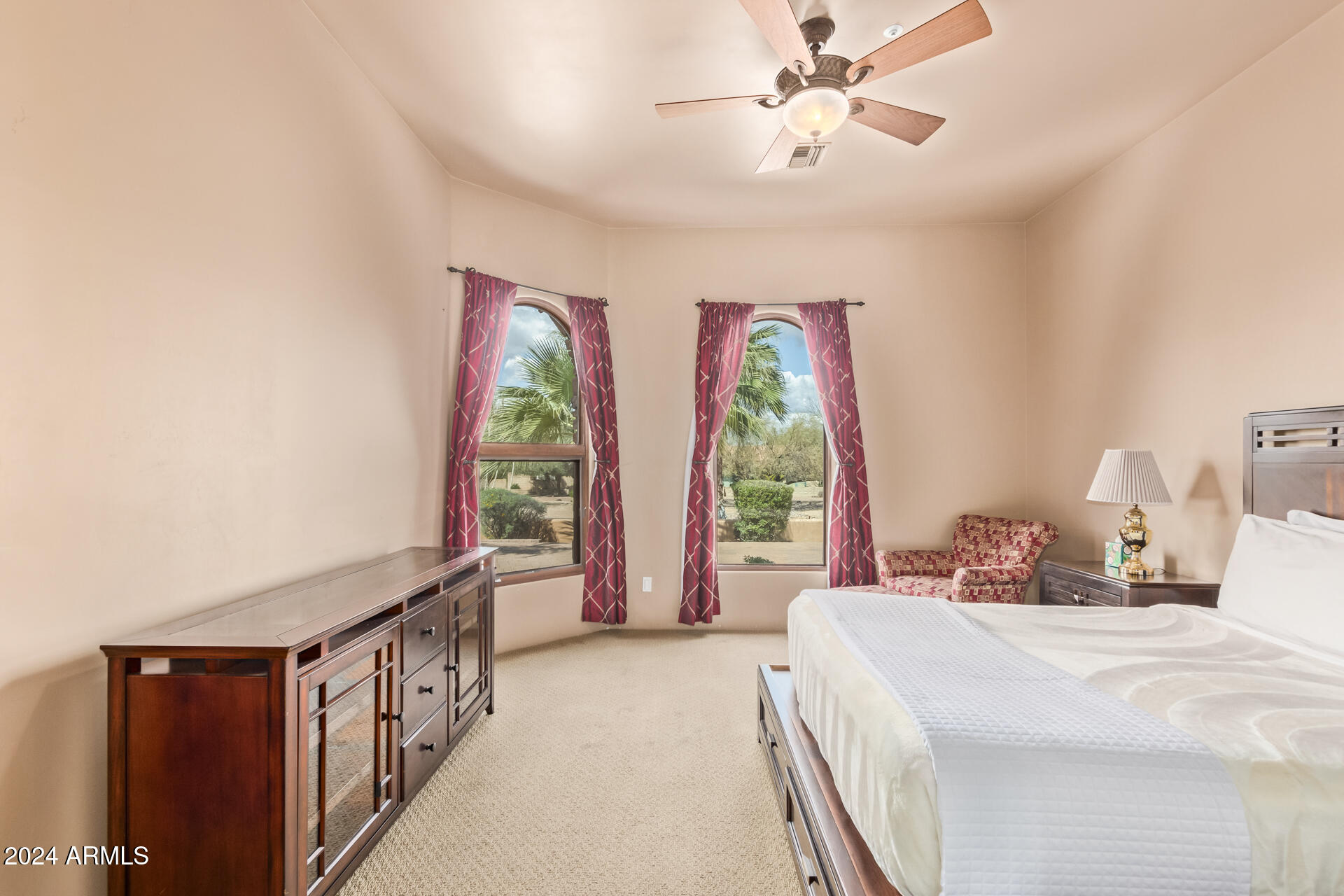 5339 East Royal Palm Road Paradise Valley, AZ 85253 - Photo 37 of 95 a bedroom with a large bed and a chandelier