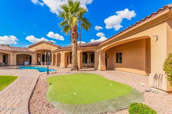 an aerial view of a house with a swimming pool and outdoor space