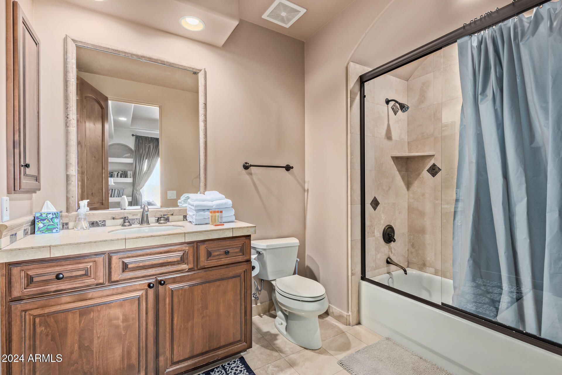 5339 East Royal Palm Road Paradise Valley, AZ 85253 - Photo 57 of 95 a bathroom with a granite countertop sink toilet a mirror a vanity and shower