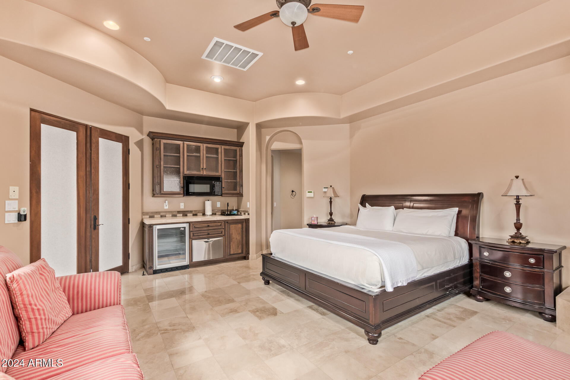 5339 East Royal Palm Road Paradise Valley, AZ 85253 - Photo 63 of 95 a spacious bedroom with a bed and ceiling fan