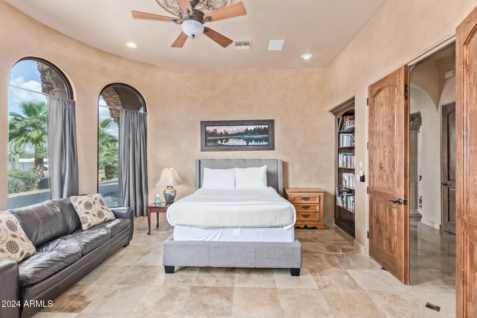 5339 East Royal Palm Road Paradise Valley, AZ 85253 - Photo 66 of 95 a spacious bedroom with a large bed and a chandelier
