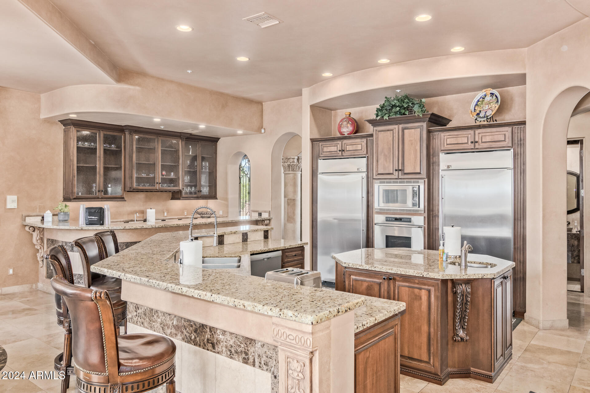 5339 East Royal Palm Road Paradise Valley, AZ 85253 - Photo 9 of 95 a kitchen with stainless steel appliances granite countertop a sink stove and refrigerator