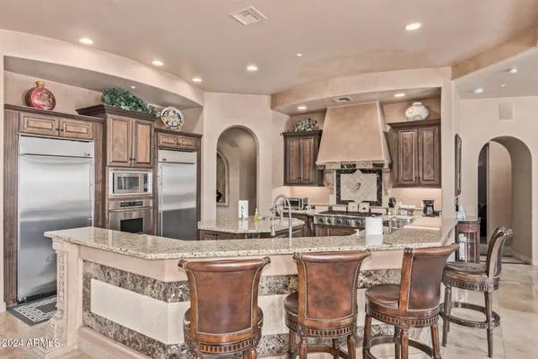a dining room with furniture a chandelier and wooden floor