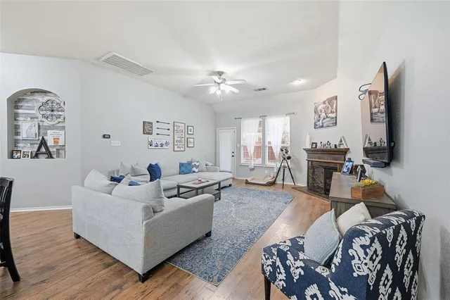 a living room with furniture and wooden floor