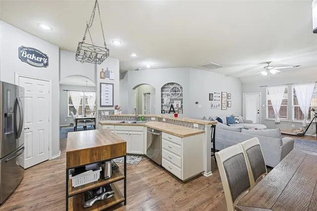 a large kitchen with a table and chairs
