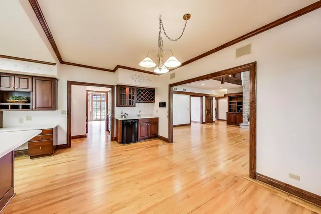 a view of a living room with wooden floor and furniture