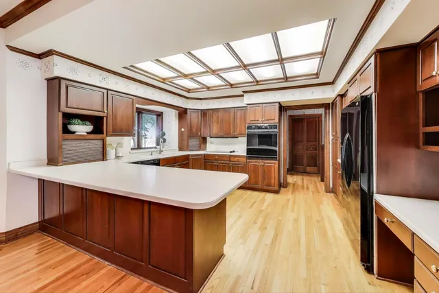 a kitchen with stainless steel appliances kitchen island granite countertop a refrigerator and a stove