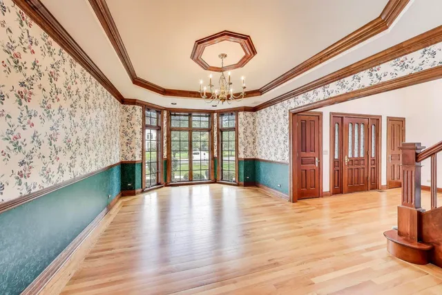 a living room with a large fireplace and a wooden floor