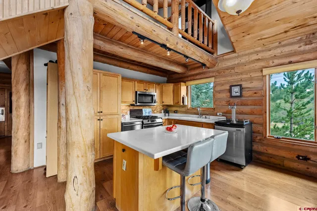 a kitchen with a stove a refrigerator and a table