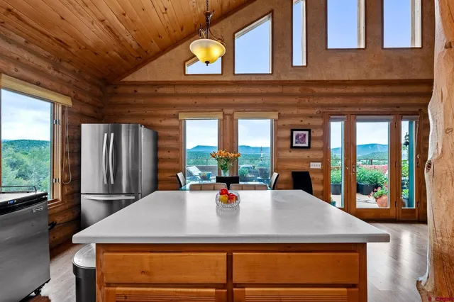 a view of a dining room with a table chairs and chandelier