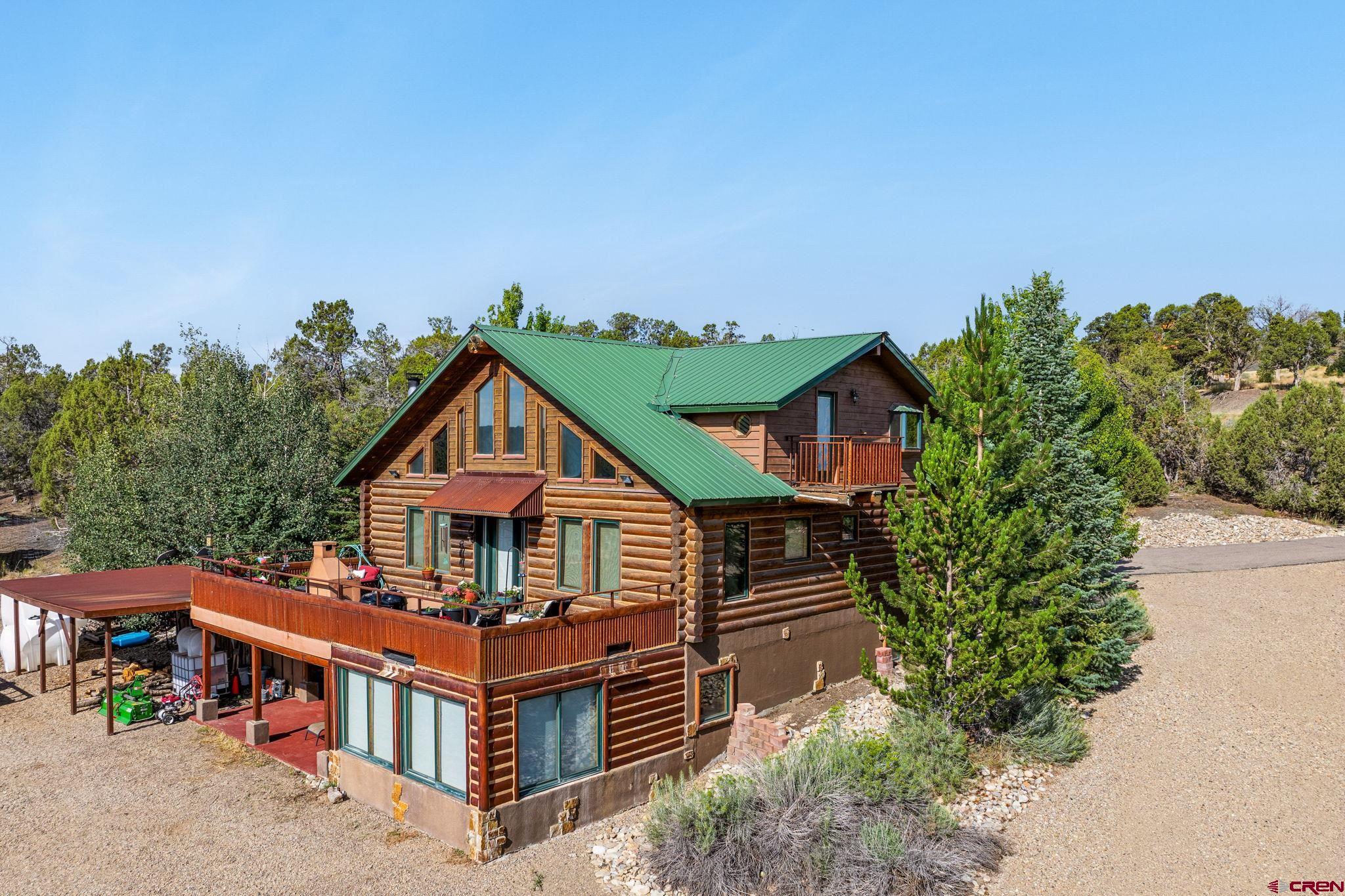 10266 Road 35 Mancos, CO 81328 - Photo 13 of 45 an aerial view of a house with balcony and trees al around