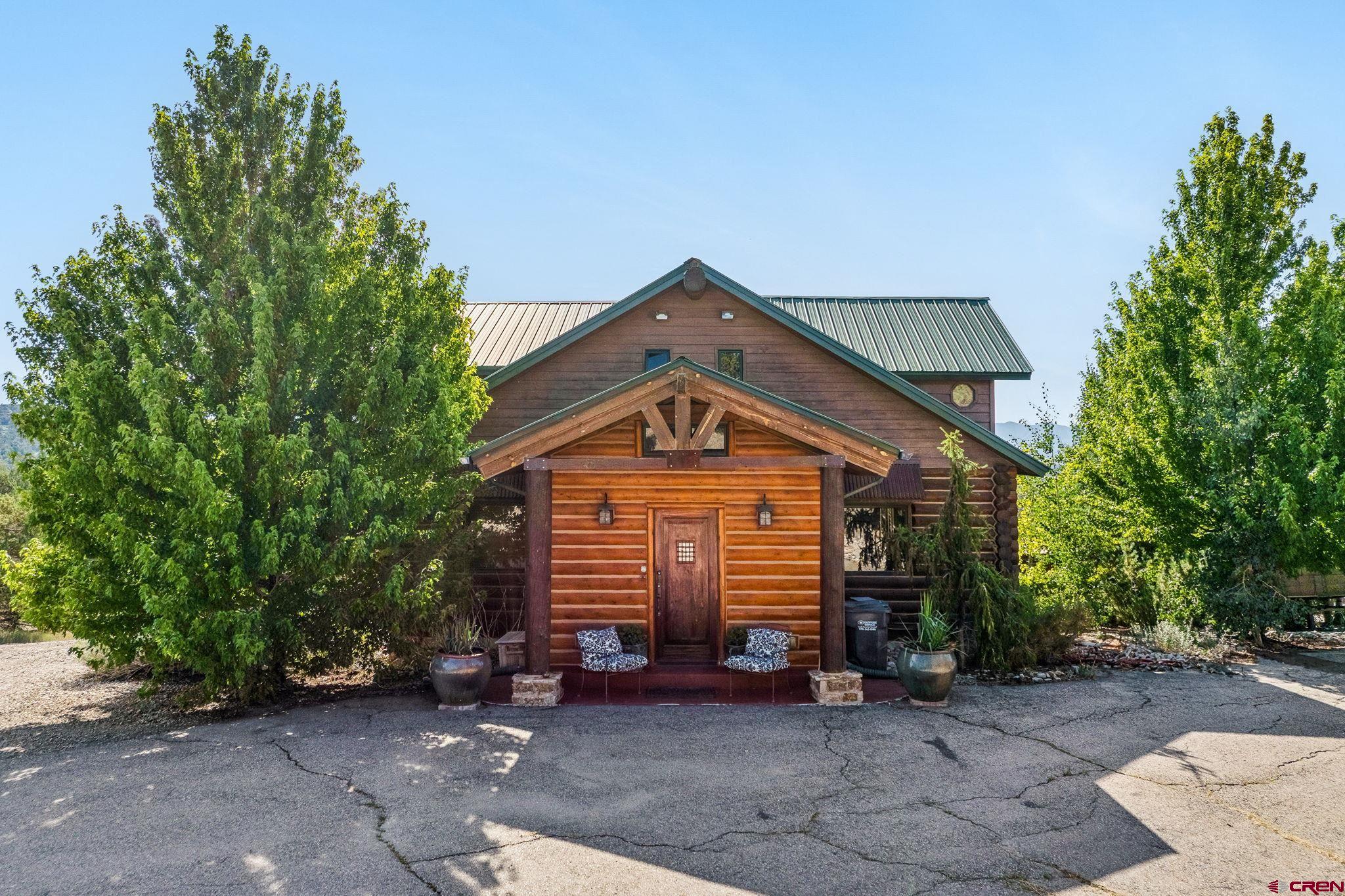 10266 Road 35 Mancos, CO 81328 - Photo 19 of 45 a front view of a house with a yard