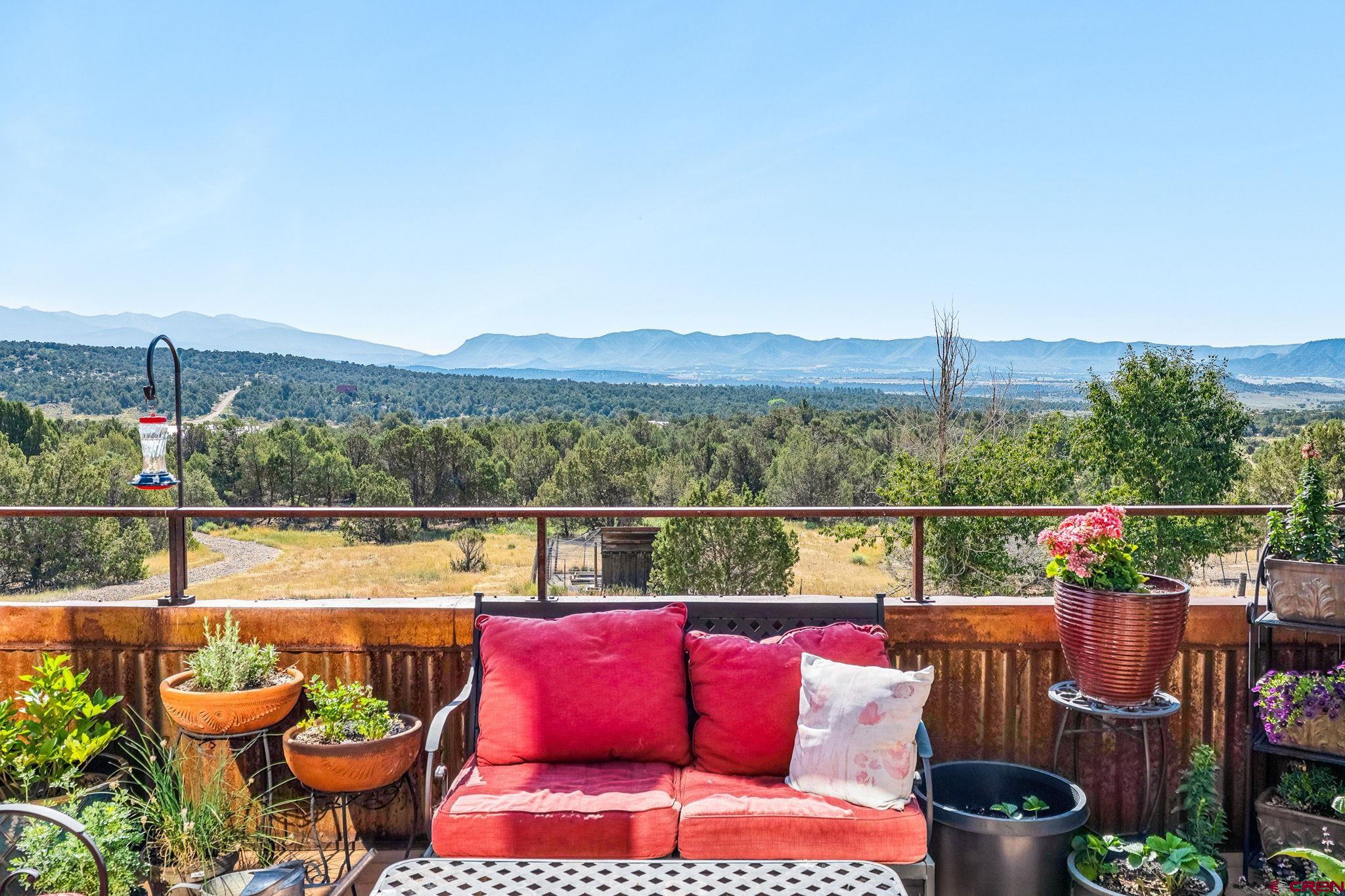 10266 Road 35 Mancos, CO 81328 - Photo 22 of 45 a view of a balcony with chairs and a potted plant