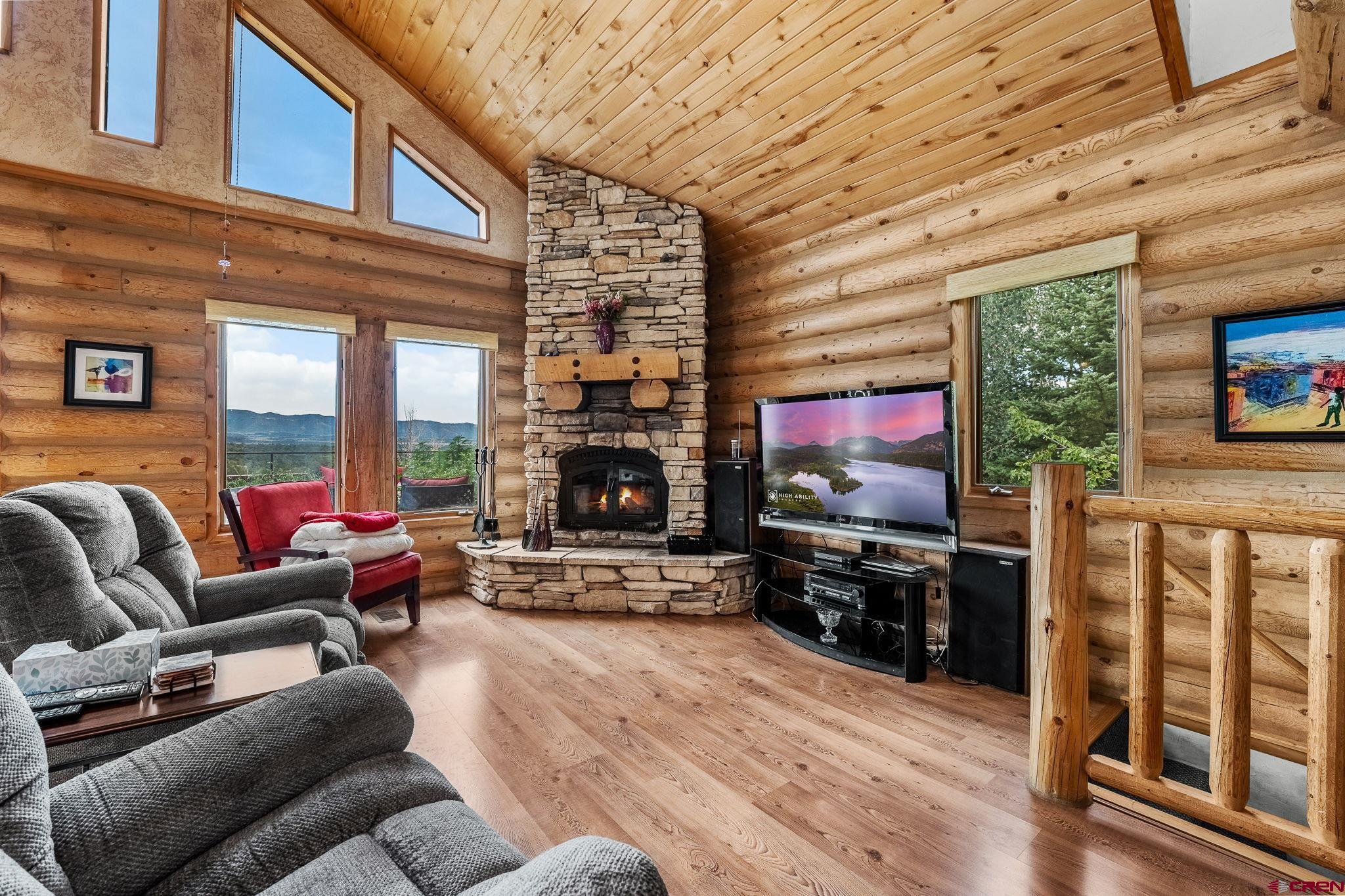 10266 Road 35 Mancos, CO 81328 - Photo 32 of 45 a living room with furniture fireplace and flat screen tv