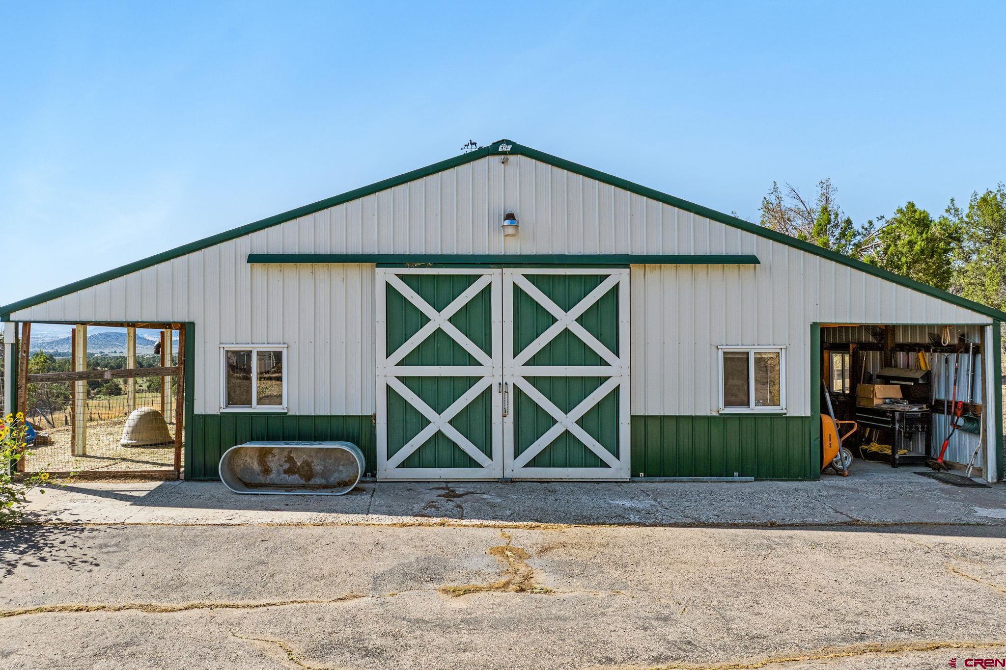 10266 Road 35 Mancos, CO 81328 - Photo 4 of 45 a front view of a house with garden