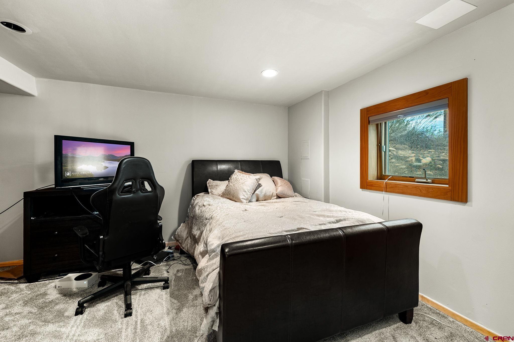 10266 Road 35 Mancos, CO 81328 - Photo 44 of 45 a bedroom with a bed and a flat screen tv