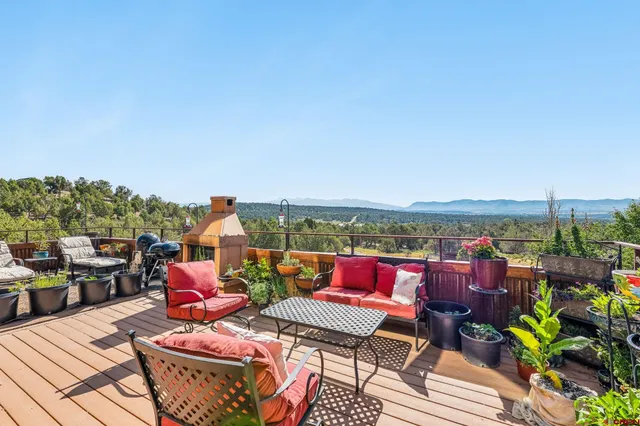 a terrace with outdoor seating and city view