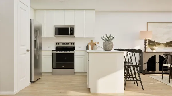 a kitchen with stainless steel appliances kitchen island granite countertop a refrigerator and a stove top oven