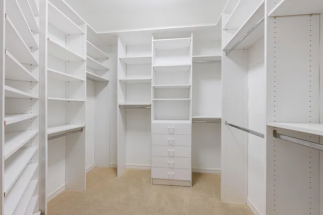 a view of walk in closet with empty racks