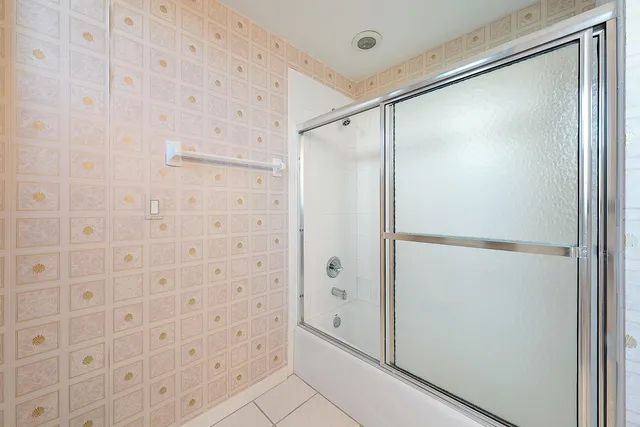 a bathroom with a glass shower door