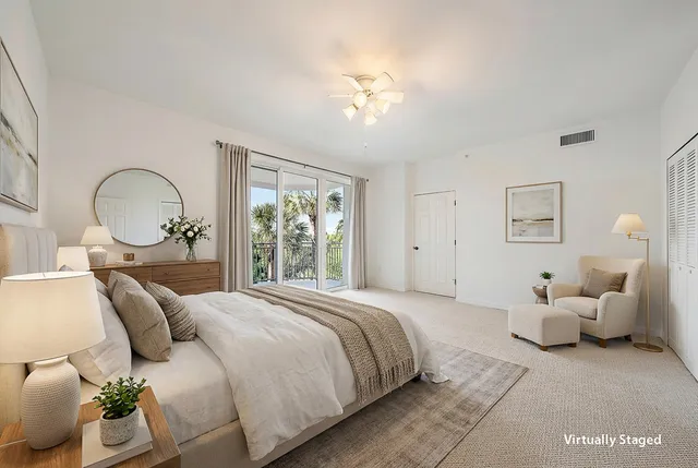 a bedroom with a large bed and a chandelier